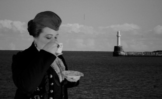 Steampunk woman drinking tea by the water, by Lloyd Dodd